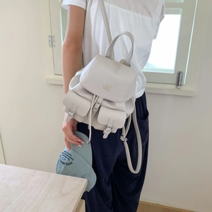 Creamy white pebbled leather backpack with drawstring closure and metal logo detail
