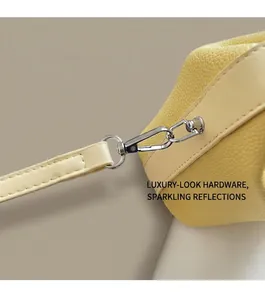 Detail of silver swivel hook and premium lychee texture leather on yellow square bag