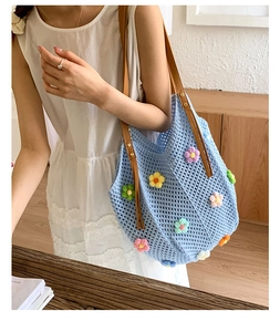Detail of crochet floral tote bag featuring handmade 3D flowers and leather straps