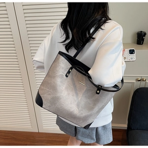 Macro detail of large grey marble pattern tote bag with reinforced black leather corners