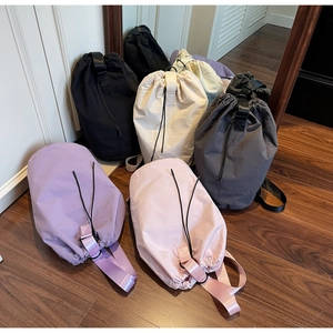 Detail view of colorful nylon drawstring bags showing premium texture and sturdy handles