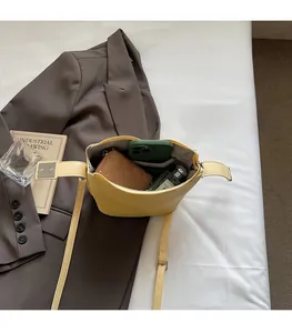 Internal view of yellow pebbled leather bucket bag showing capacity for daily essentials