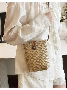 Rainbow woven mini crossbody bag made of natural straw with button closure and slim strap