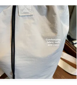 Close-up of comfortable soft nylon fabric texture and drawstring on casual white bucket bag