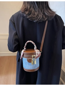 Brown leather and blue denim bucket bag with silk scarf handle on model back view