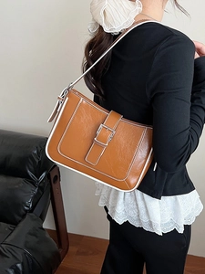 Vintage brown shoulder bag with white contrast stitching and a silver square buckle detail