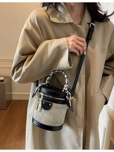 Minimalist canvas and black leather bucket bag with printed silk scarf handle detail