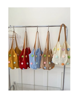 Collection of colorful floral crochet tote bags featuring brown leather shoulder straps