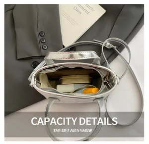 Internal view of metallic silver crossbody bag showing storage space for cosmetics