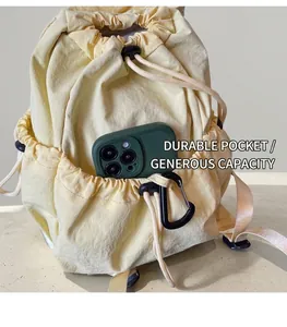 Detail of the durable nylon backpack side pocket showing large phone storage capacity