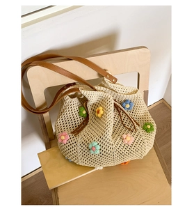 Detail of crochet floral tote showing beige hollow knit pattern and leather drawstrings