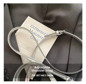 Detail of adjustable silver metallic leather strap with buckle for crossbody bags
