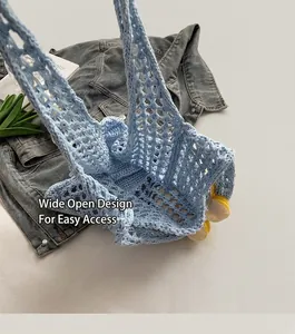 Close-up of light blue hollow crochet bag showing mesh knit texture and open top design