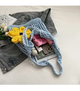 Detail of blue crochet tote with yellow sunflower showing spacious inner capacity