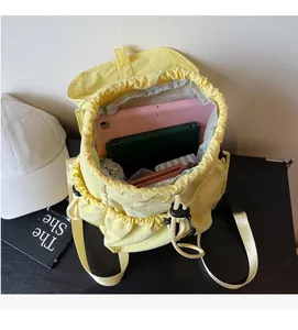 Detailed interior of yellow nylon backpack showing large capacity and drawstring closure