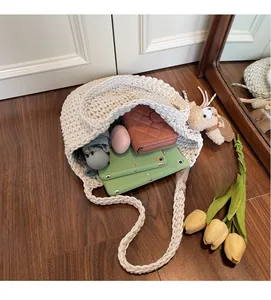 Detailed view of the woven cotton bucket bag interior holding a tablet and umbrella