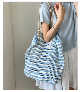 Detail of blue and white striped crochet tote bag with adjustable white leather strap