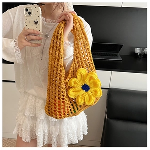 Detail of yellow crochet knit tote bag with large 3D handmade sunflower decoration
