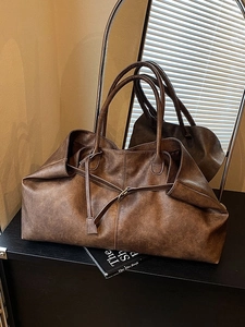 Vintage brown oversized tote bag with soft leather texture and long shoulder straps