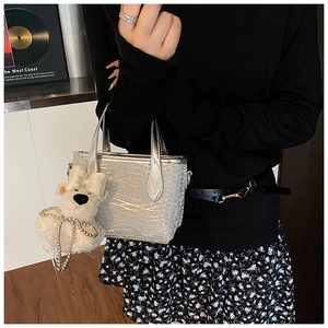 Silver glitter handbag with wavy texture and white teddy bear pearl charm detail
