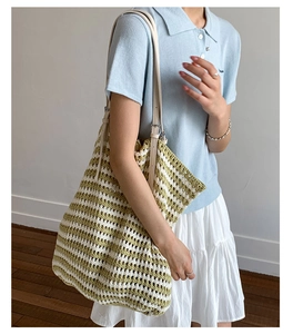 Detail of green and white striped woven tote bag with premium leather shoulder straps