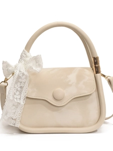 Elegant cream-colored square handbag with lace bow detail and gold metal hardware