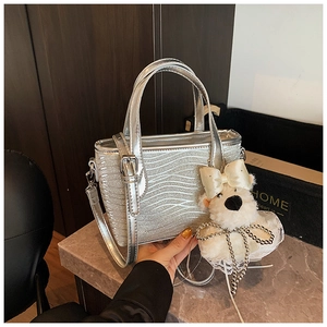 Detail of silver ripple texture handbag with cute white plush bear charm decoration