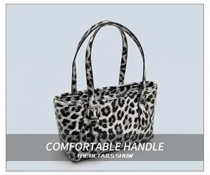 Detail shot of leopard print handbag with sturdy round handles and metal zipper closure