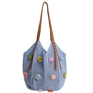 Light blue crochet tote bag with colorful floral patterns and brown fringe handles