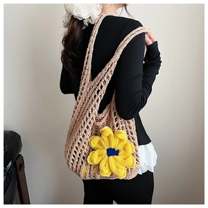 Detailed macro view of the handmade crochet mesh bag featuring a 3D yellow sunflower design