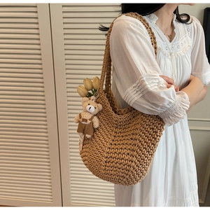 Detail of camel woven crochet shoulder bag with teddy bear charm and tulip pendant