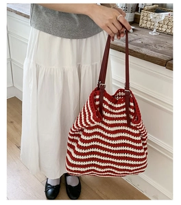 Detail of red and white striped crochet tote with adjustable leather shoulder strap
