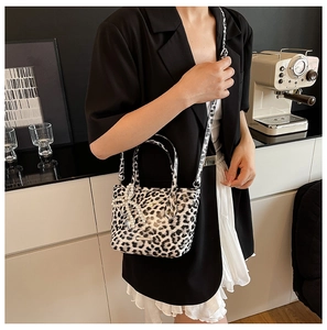 Leopard print crossbody bag detail with pearl bow charm and adjustable strap