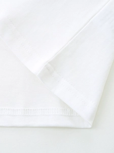 Close-up of boys white cotton T-shirt showing detailed hem stitching and knit texture
