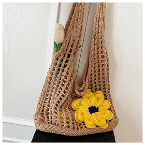Detail of hollow woven knit tote bag with 3D sunflower and crochet mesh texture