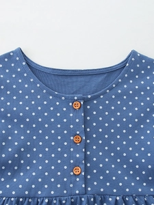Blue knit girls' dress with white polka dots and three brown wooden buttons on the neckline
