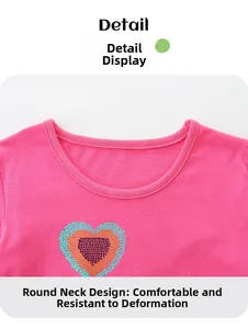 Close-up of a pink girl's t-shirt with a colorful gradient heart and reinforced crew neck