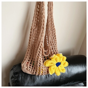 Close-up of khaki crochet tote bag featuring a large yellow sunflower 3D accent