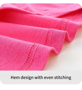 Detail view of smooth stitching and hemline on a peach pink cotton knit t-shirt
