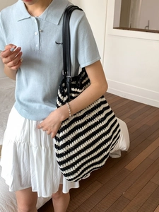 Fashionable black and white striped woven tote bag with adjustable leather shoulder straps