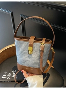 Retro light blue denim and brown leather bucket bag with gold lock and handle strap