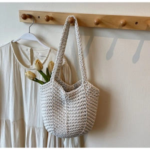 Detailed close-up of cream handmade woven tote bag with intricate crochet texture