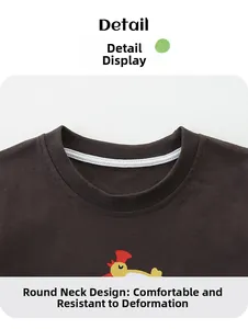 Détail du col rond côtelé avec motif de coq jaune sur un t-shirt en coton pour garçon