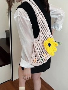 Hollow out crochet tote bag with large yellow flower detail for beach vacation
