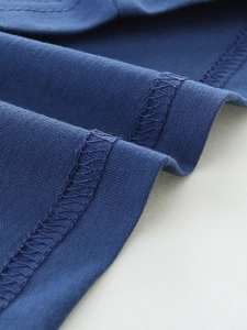 Detail of dark blue cotton kids T-shirt with premium double-stitch sewing and knit texture