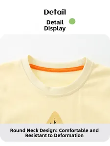 Detail view of cotton crew neck with orange reinforced tape on boy's yellow t-shirt