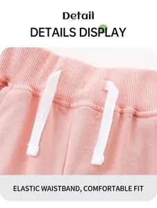 Detail of pink cotton shorts featuring an elastic waistband and white flat drawstring