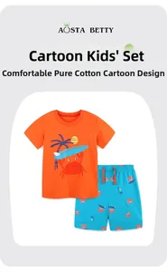 Detail of soft cotton boys' summer set featuring cartoon crab and surfing prints