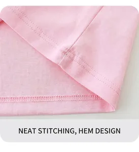 Detailed close-up of smooth double-stitch hem on soft pink cotton girls' t-shirt