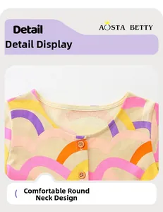 Detail view of colorful rainbow pattern cotton dress with orange buttons and round neck